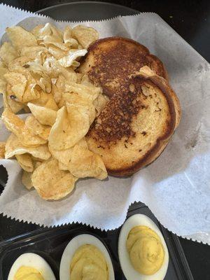 Hot ham and cheese with kettle chips and deviled eggs