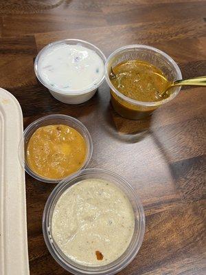 Raita, soup with the spoon in it that comes with dosa, and the sauces that come with dosa