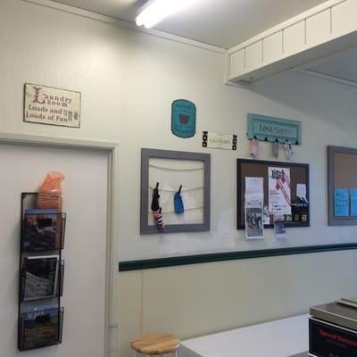 a few signs, new bulletin boards, newspaper rack and bench to help spruce up the place. Suggestions for a new wall paint color?