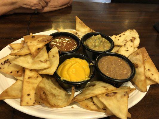 Chips  with salsa, guacamole, bean dip, & nacho cheese.