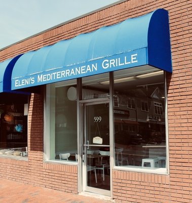 Façade with blue awning