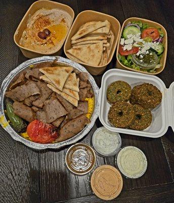 Gyro plate, hummus, pita bread, salad and falafel along with assorted sauces ranging from mild to spicy.