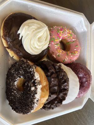 Pink sprinkle, white Cream, cookies & Cream, chocolate dipped sourdough, frosted red velvet, glazed red velvet