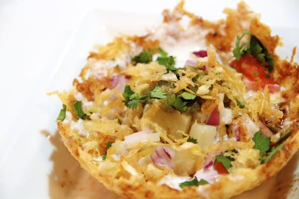 Tokri Chaat - a basket made of shredded potatoes filled with soft lentil dumplings, yogurt, onions, and sweet & spicy chutney