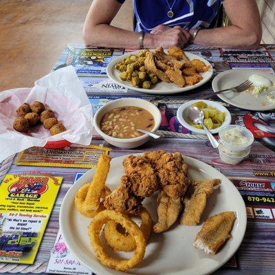 Fish and chicken combo with onion rings.  .  Beans coleslaw hushpuppies and pickled tomatoes are all good.