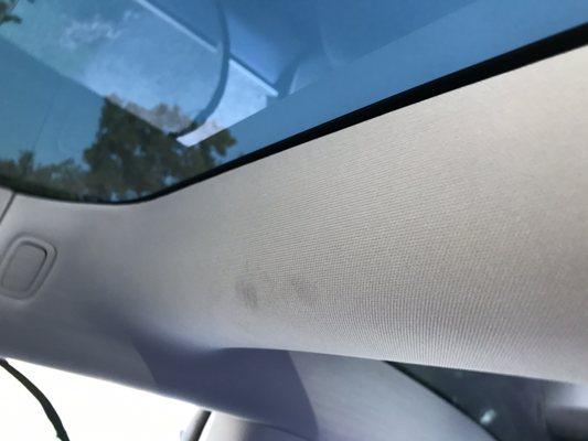 Grease stains all over visor and ceiling of car, car was new condition when dropped off for external repairs!