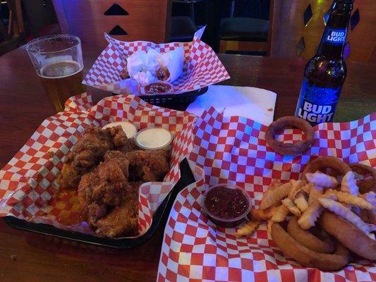 Chicken wings, onion rings, beer and French fries. Super good and flavorful!