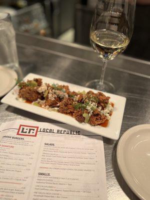 Chicken livers with buffalo sauce, crumbled blue cheese and sliced celery