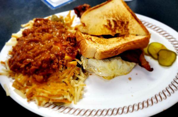 Egg, bacon and cheese sandwich with hash browns covered in jalapeño, cheese and chili.