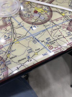 Tables have aviation maps from various cities!