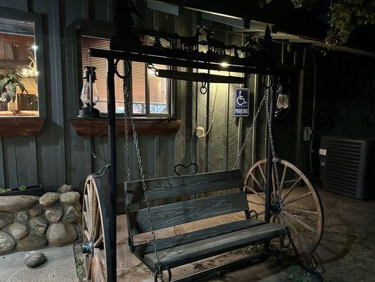 Swing with wheels outside front of restaurant