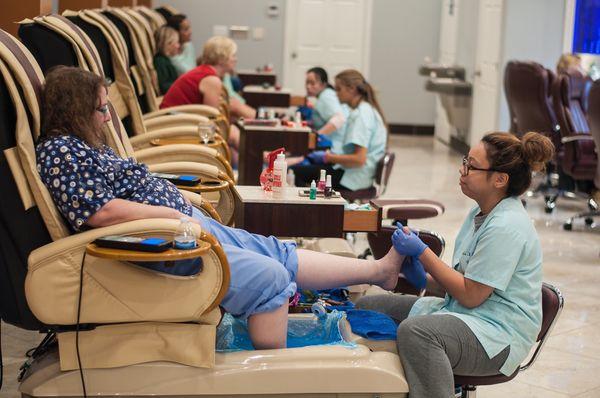 Coworker receiving a pedicure.