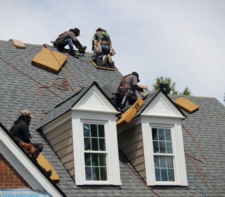 In-house crew finishes installing shingles