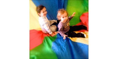 learning to balance in motion is fun on the parachute ride at FunikiJam Music toddler classes