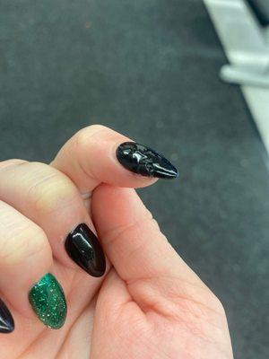 Difficult to see because it's black but it's bubbled up and tore up. Also the shape of my nails are not all the same.