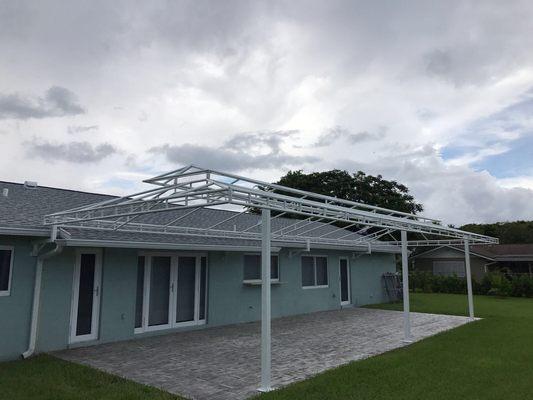 Patio awning with a gazebo hood. White finish structure