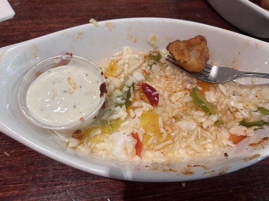 The bed of slaw and pickled peppers the buffalo cauliflower was on