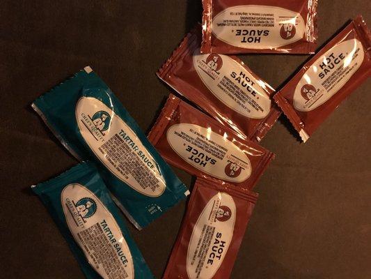 Two packets of tartar sauce and five packets of hot sauce for an order containing three pieces of fish and only one "hot sauce-able" side