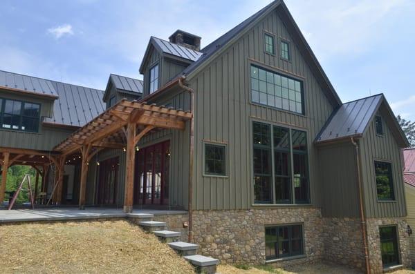 Progress photo during construction.  Timber frame.  Magnificently tall windows frame the mountain view.