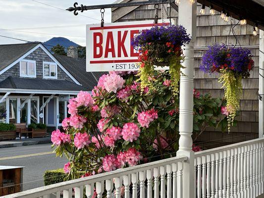 The bakery porch with spring flowers in bloom.