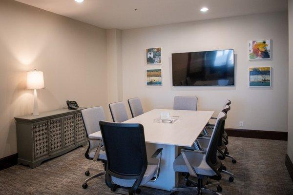 Spacious conference room with large screen television