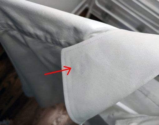 Purple stain on white shirt after dry cleaning.