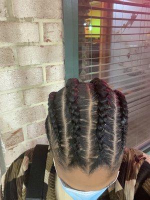 Crocked straight back cornrows that should've been feed-ins but look like trash.