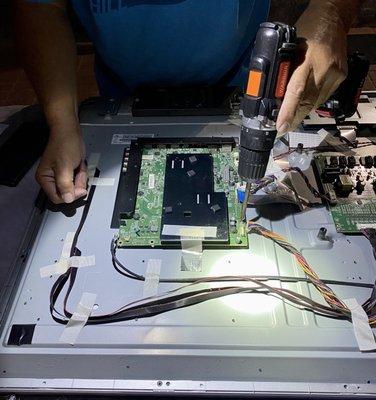 Todd carefully removing the faulty circuit board.