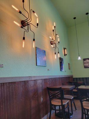 Interesting lighting fixtures in a nice and comfortable seating area.