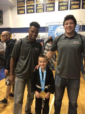 My son with Coach Ryan and Coach Josh at the AZBJJF tournament.