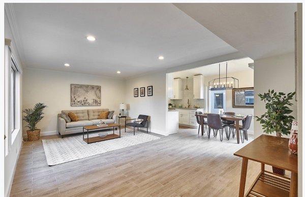 Living room installed Othello oak wood like porcelain, baseboards, recessed lighting and modern farmhouse chandelier in dining.