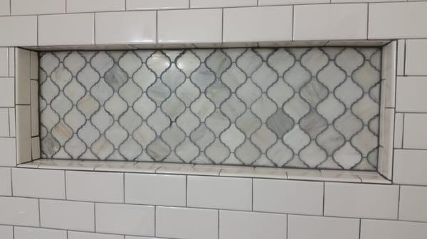 Marble mosaic tiles and custom recessed shelf