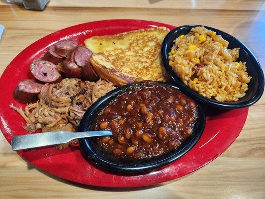 Jalapeno cheddar sausage, pulled pork,  BBQ dirty rice, baked beans, garlic toast.