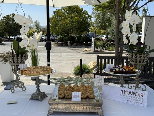 A beautiful dessert display by "A Nouveau Brownies & Desserts" using our silver trays for the 2024 Festival of Trees Fundraiser.