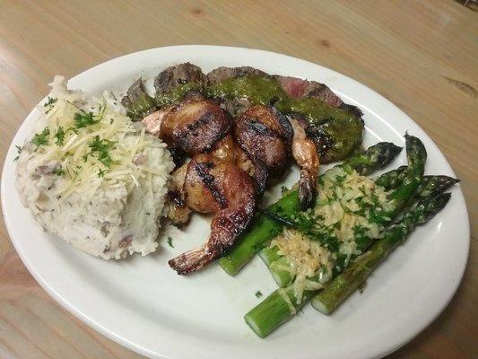 Flat iron top with beacon wrapped bbq  prawns served with asparagus and mash potato.