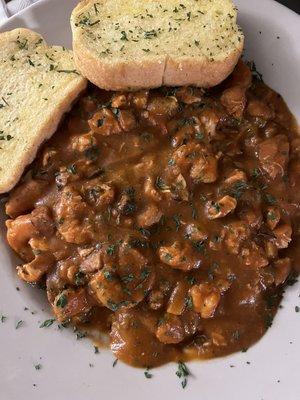 Cajun bowl with shrimp, sausage and chicken over rice with garlic bread