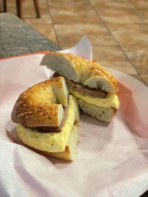 Sausage and egg on a spinach Asiago bagel