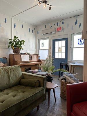 The back area that feels like someone's living room, with a chess set and some board games