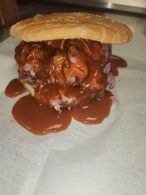 Suoer roast beef sandwich served on onion roll with cheese barbeque sauce and mayonaise