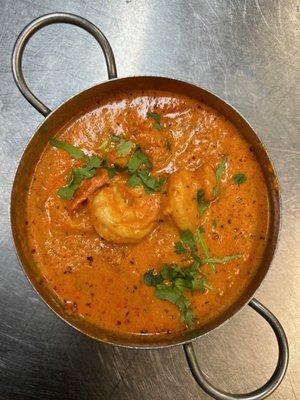 Prawns marinated with yogurt and spices grilled and then cooked in a creamy tomato sauce.