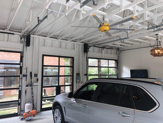 Full view glass garage doors with custom track to get the doors closer to the ceiling.