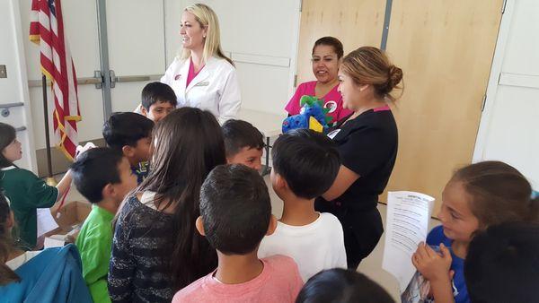 Blanco Family Dental Volunteering to teach children at one of our local schools the importance of proper oral hygiene.