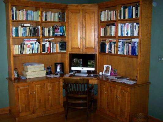 This Home Office in Wellesley features bookmatched Tiger Maple raised panels, space for files and storage, and keyboard pullout.