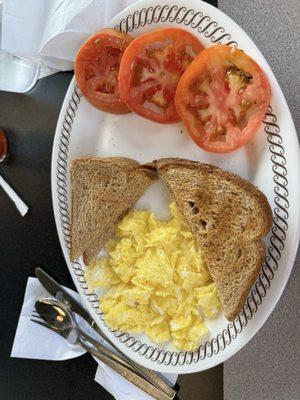 Breakfast meal with sliced tomatoes for six dollars.