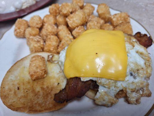 Breakfast burger with an egg and bacon. SO GOOD. One tater tot sat up on my bun. He was eaten first.