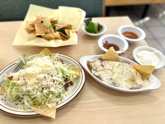 Carne Asada Beef tostada extra cheese, side of the most delicious refried beans ever... Chips and salsa..