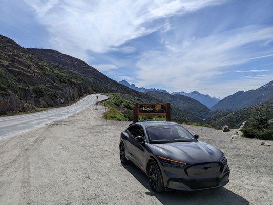 The Mustang Mach-E at the Welcome to Alaska sign on the Klondike Highway