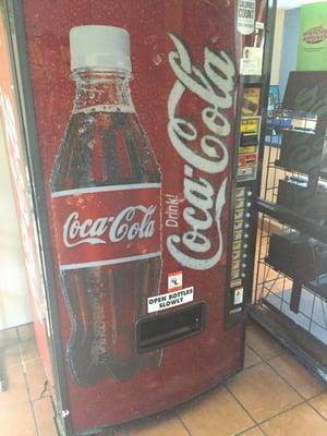 Vending machine in lobby for customers takes cash and coins.