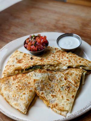 Poblano Quesadilla with mexican cheeses, salsa fresca, crema, quemada salsa, flour tortilla