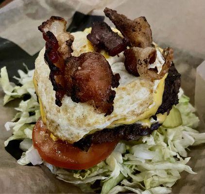 The Big Weezy ATW with 2 Patties, 2 Slices American Cheese, Bacon and a Fried Egg and no bun on a bed of lettuce.